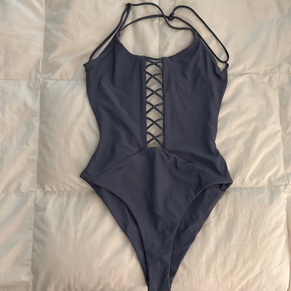 Rip curl one piece, criss cross cut out in front. Exposed back.